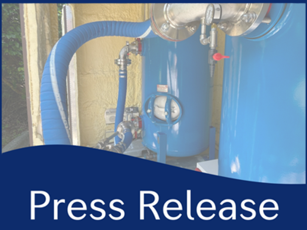 Press release image featuring a blue filtration system with connected hoses and pipes, highlighting water treatment equipment.