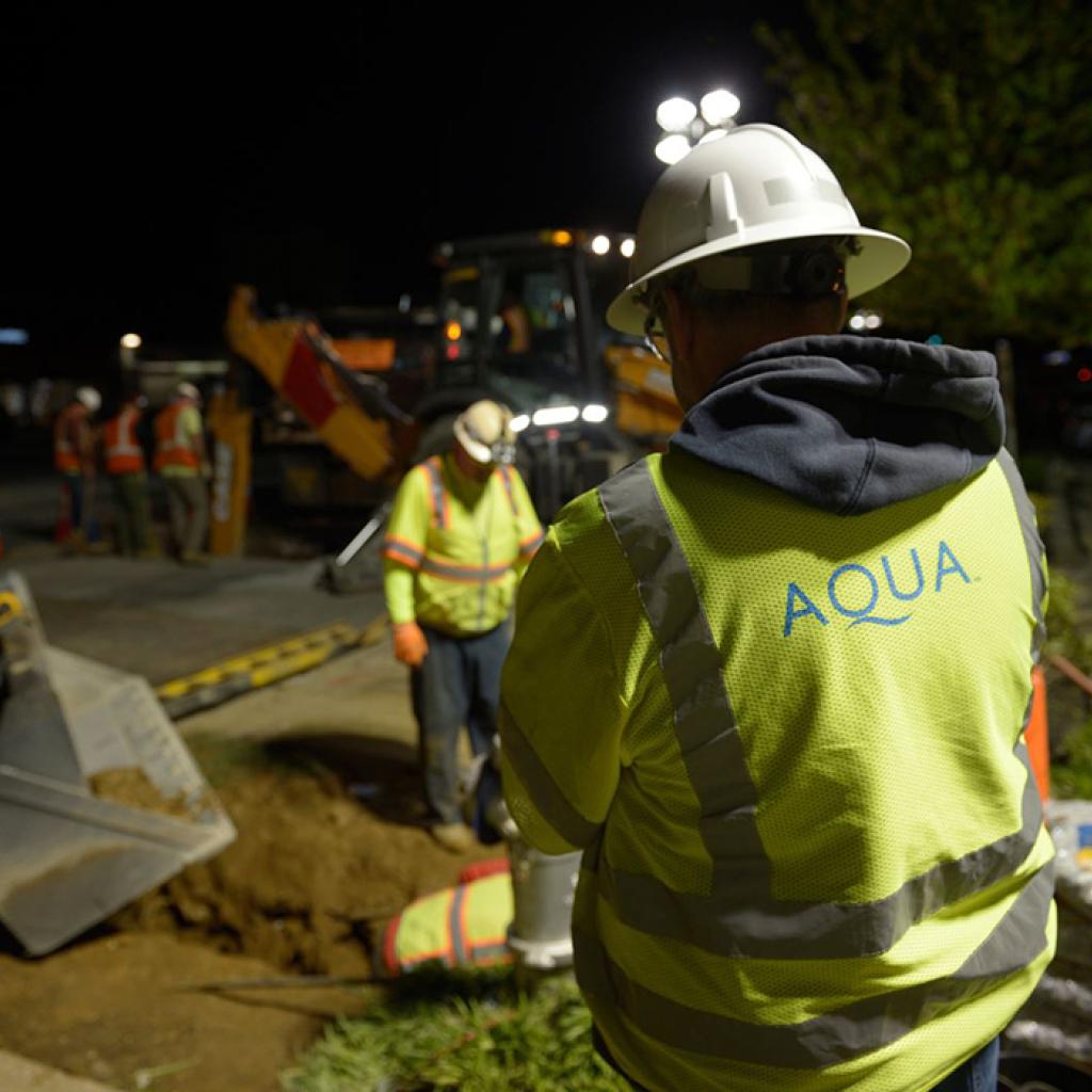 Employees digging at night