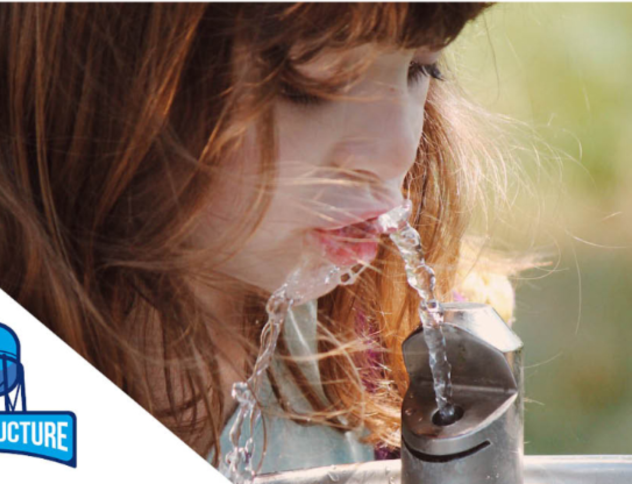 A young child drinks water from a fountain outdoors. The image includes the Aquastructure logo with a water tower icon.