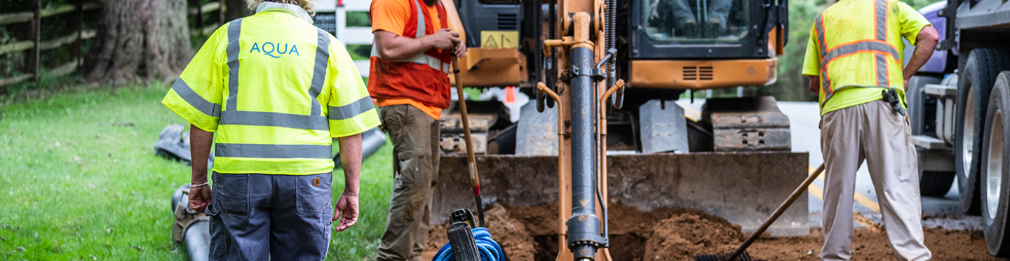 workers digging hole for pipes